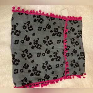 NWOT Fun scarf with gray/black cheetah design and pink Pom Pom trim.